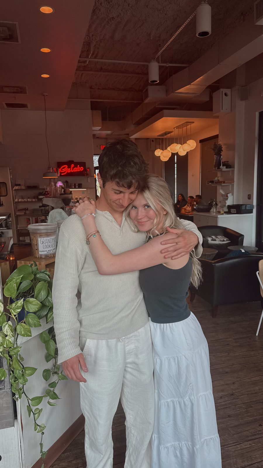 Simon and Francesca hugging in a gelato café